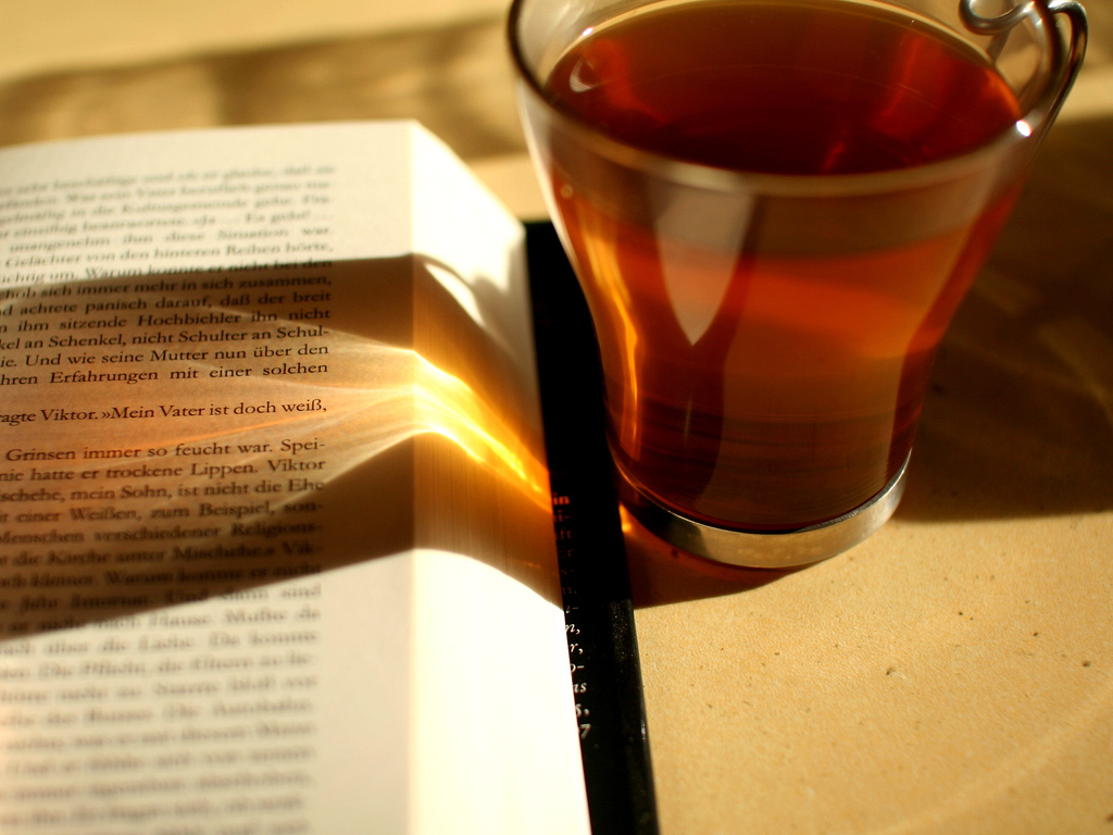 Drinking tea with an open book